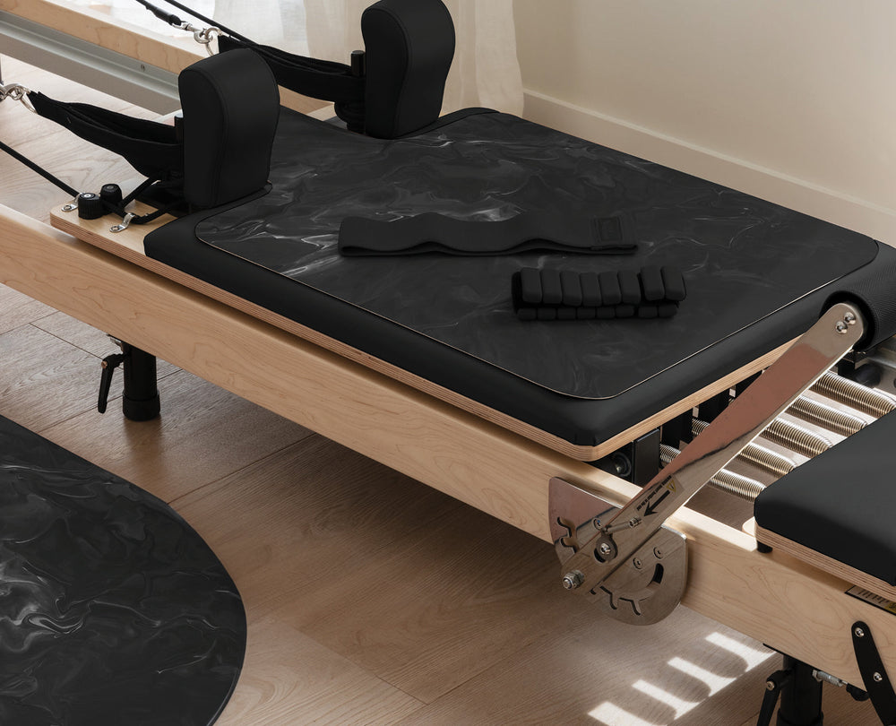 Blush Pilates Pack with Reformer Mat and Ankle Weights on Pilates Reformer | Your Reformer