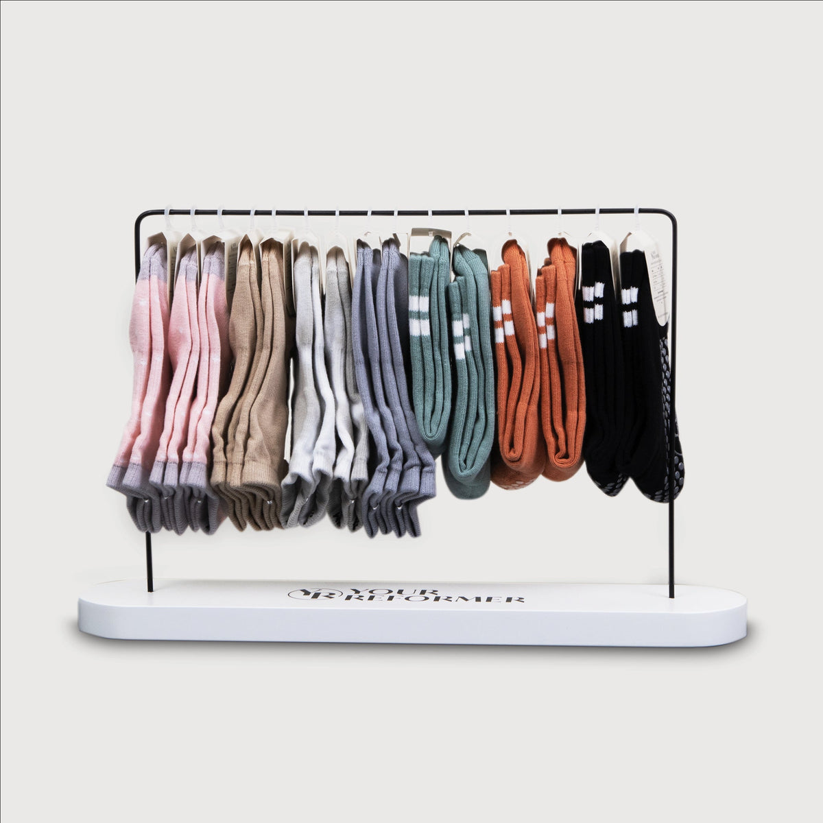 White Metal Sock Display Stand with Grippy Pilates Socks - Front View | Your Reformer