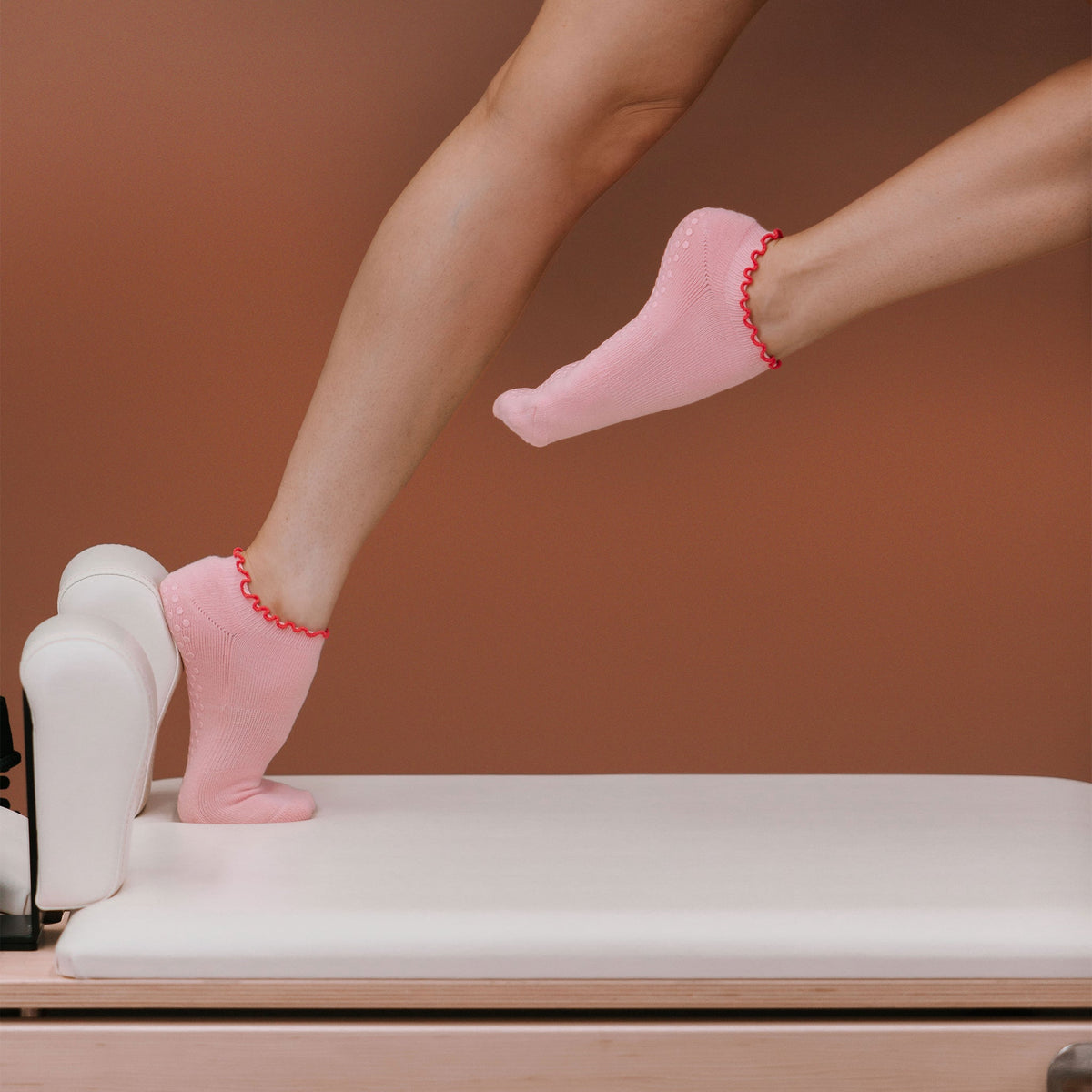 Hot Pink Ankle Grip Socks - On Model Pilates Pose | Your Reformer