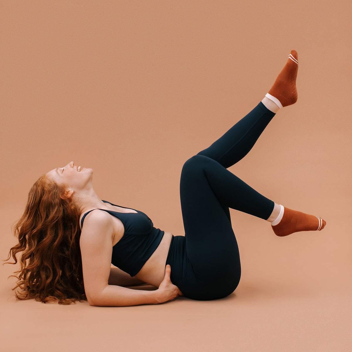 Rust Ankle Grip Socks - On Model Pilates Movement | Your Reformer
