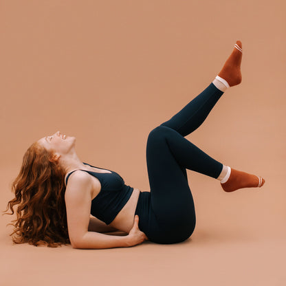 Rust Ankle Grip Socks - On Model Pilates Movement | Your Reformer