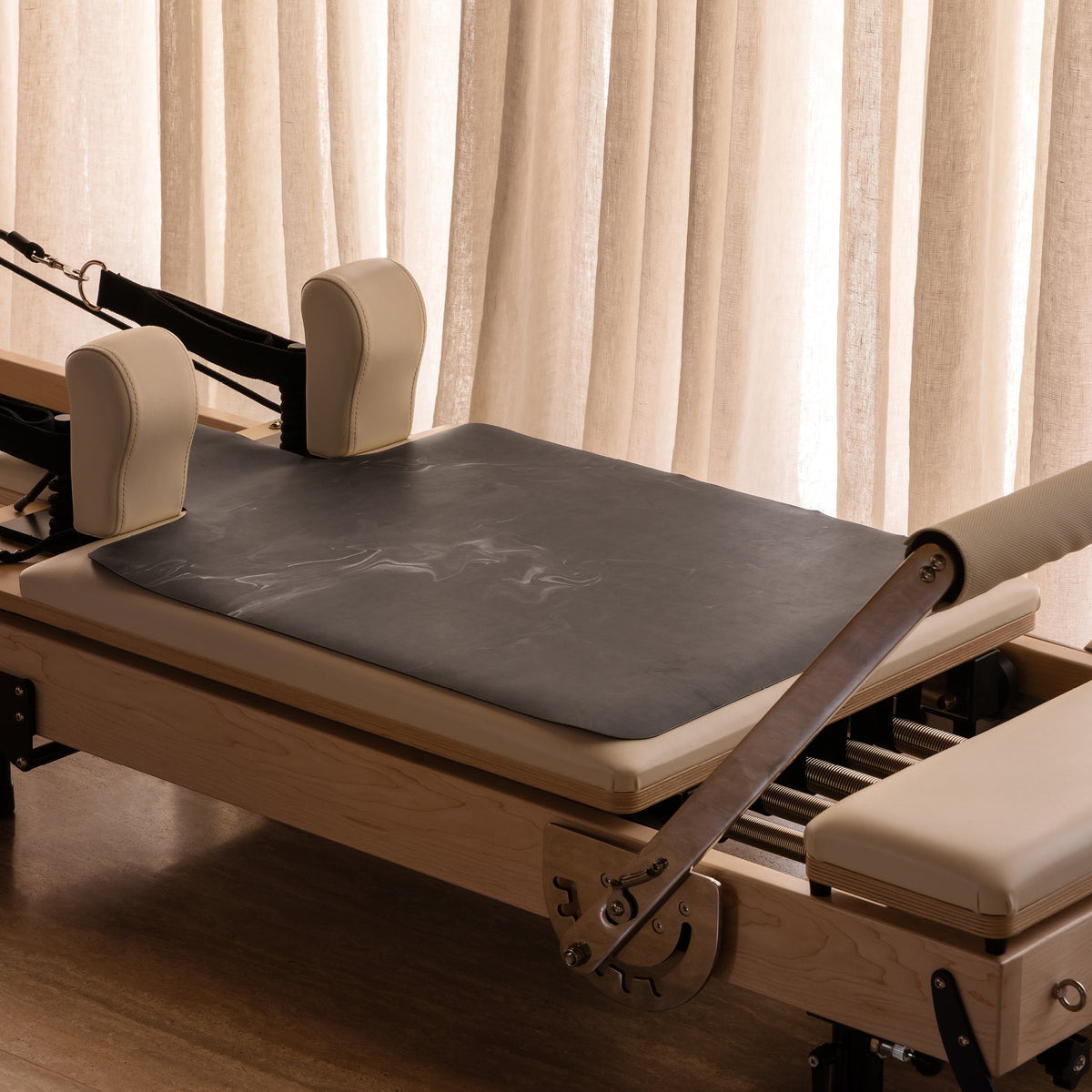 Black Non Slip Reformer Mat on Pilates Equipment - Lifestyle View | Your Reformer
