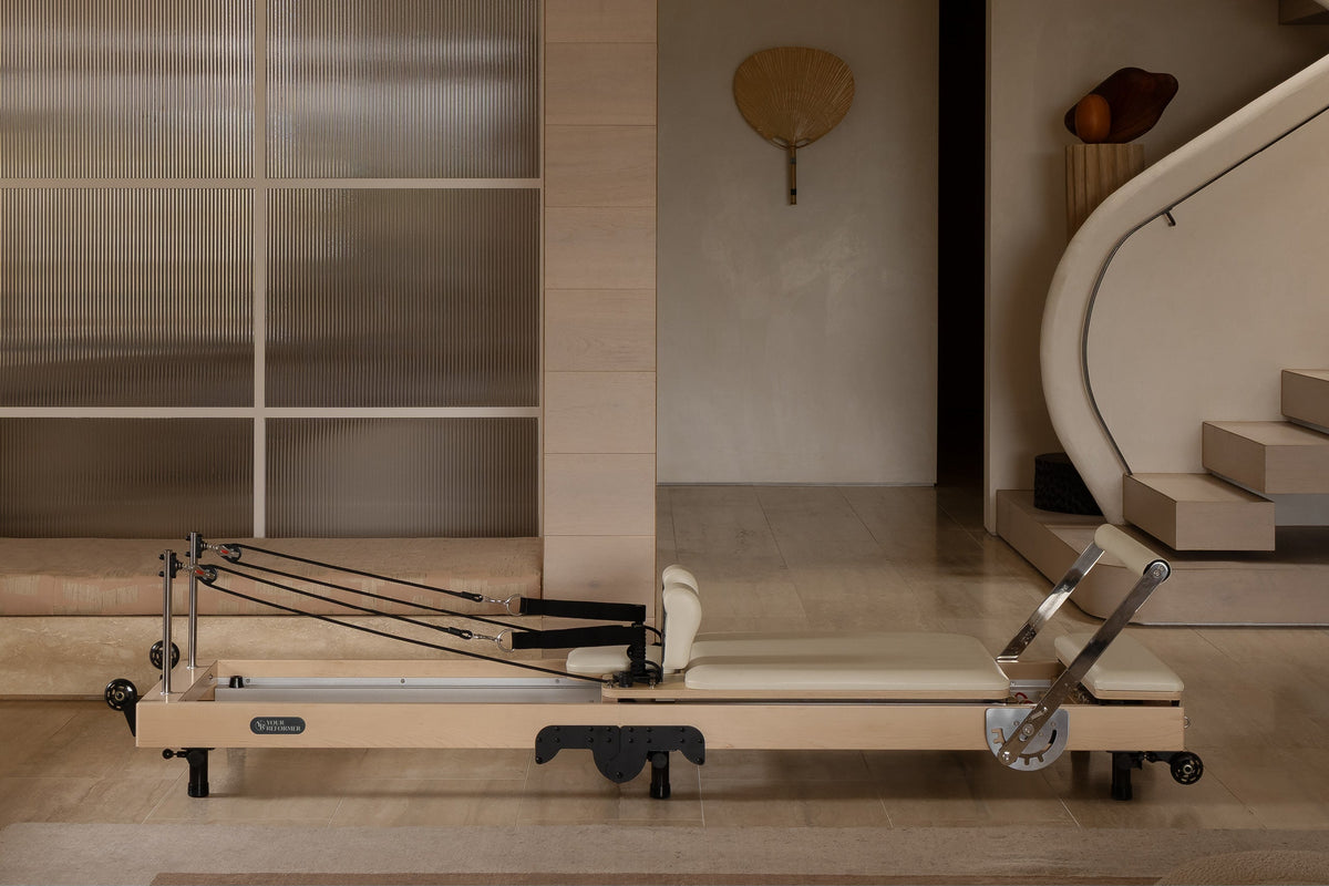 Maple Wood Foldable Pilates Reformer - Side Profile with Ivory Upholstery | Your Reformer