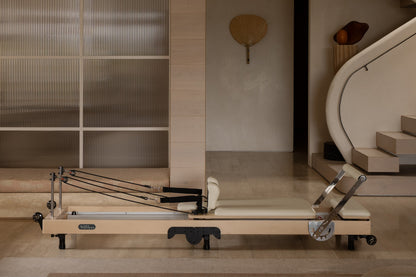 Maple Wood Foldable Pilates Reformer - Side Profile with Ivory Upholstery | Your Reformer
