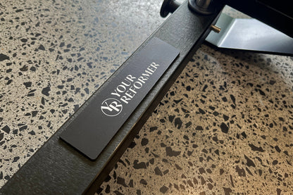 Black Studio X Frame - Your Reformer Logo Branding Detail on Metal Base | Your Reformer
